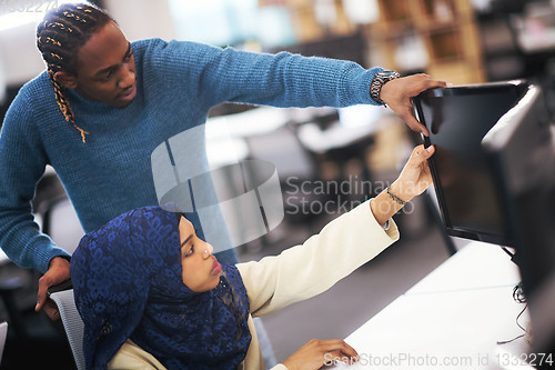 Image of young black muslim female software developer at work