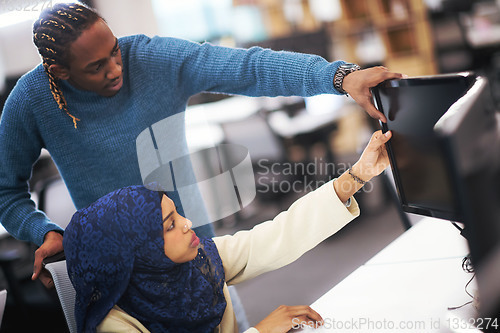 Image of young black muslim female software developer at work