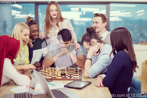 Image of multiethnic group of business people playing chess