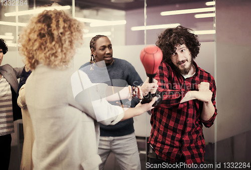 Image of multiethnics business team boxing at office