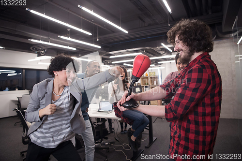 Image of multiethnics business team boxing at office