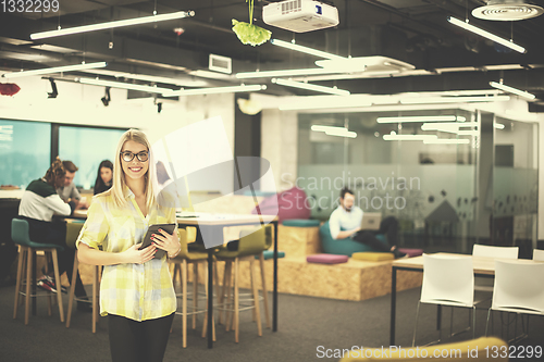 Image of blonde businesswoman working online using digital tablet