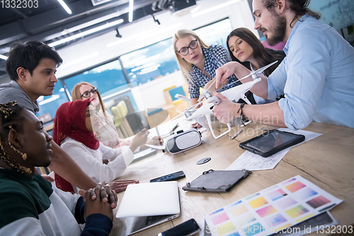 Image of multiethnic business team learning about drone technology