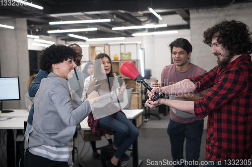 Image of multiethnics business team boxing at office