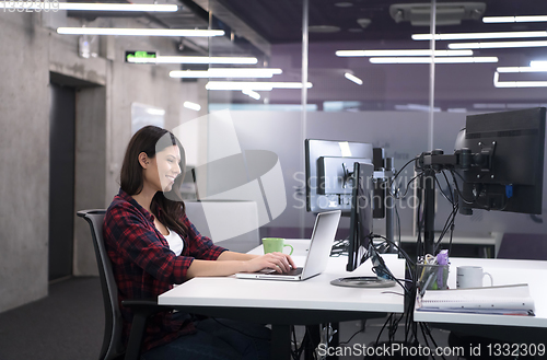 Image of female software developer using laptop computer