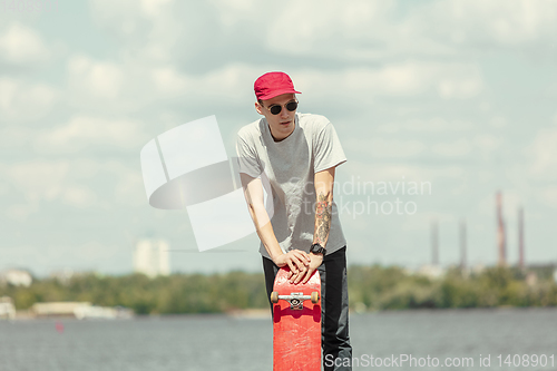 Image of Skateboarder at the city\'s street in sunny day