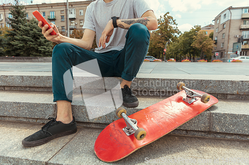 Image of Skateboarder at the city\'s street in sunny day