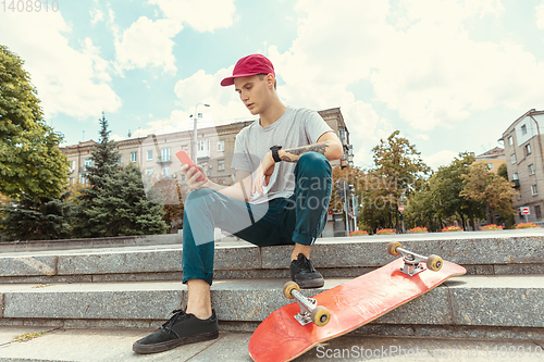 Image of Skateboarder at the city\'s street in sunny day