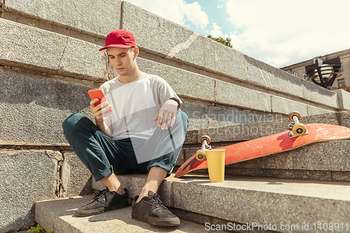 Image of Skateboarder at the city\'s street in sunny day