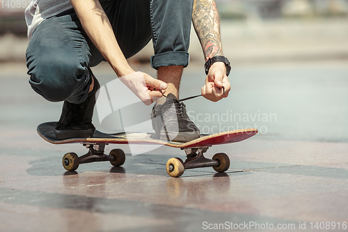 Image of Skateboarder at the city\'s street in sunny day