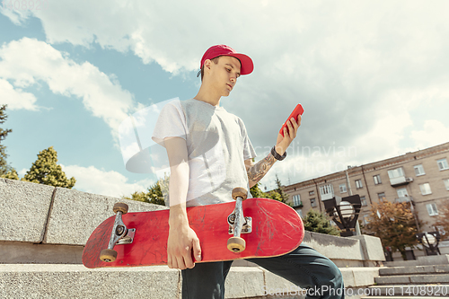 Image of Skateboarder at the city\'s street in sunny day
