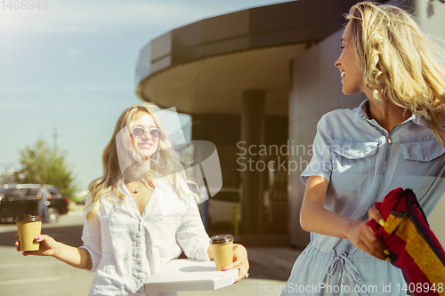 Image of Young lesbian\'s couple preparing for vacation trip on the car in sunny day