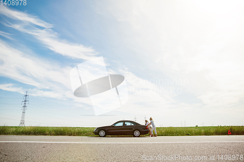 Image of Young lesbian\'s couple going to vacation trip on the car in sunny day