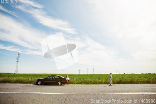 Image of Young lesbian\'s couple going to vacation trip on the car in sunny day