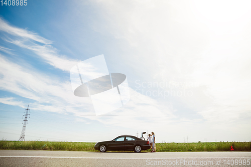 Image of Young lesbian\'s couple going to vacation trip on the car in sunny day