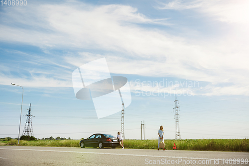 Image of Young lesbian\'s couple going to vacation trip on the car in sunny day