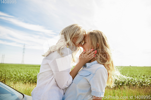 Image of Young lesbian\'s couple going to vacation trip on the car in sunny day