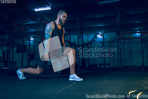 Image of Young healthy man athlete doing exercise in the gym