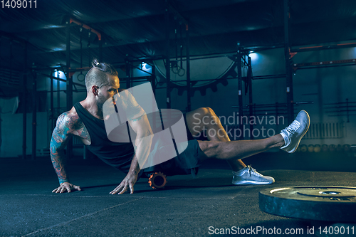 Image of Young healthy man athlete doing exercise in the gym