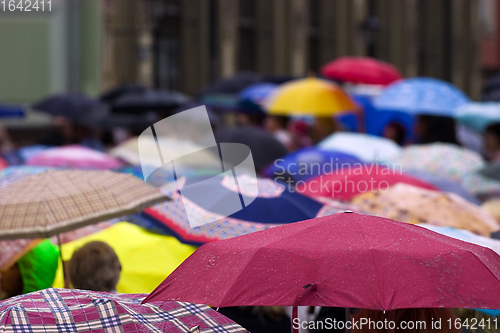 Image of Crowd of people with umbrellas