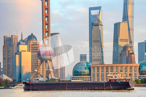 Image of Barge by sunset Shanghai skyline