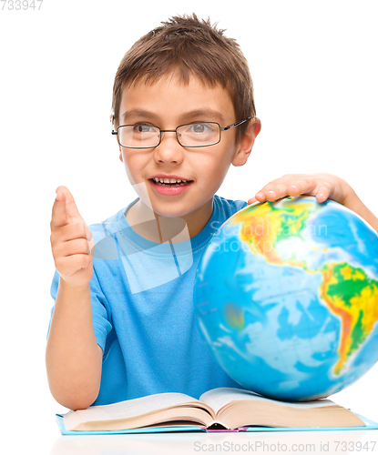 Image of Little boy is holding globe