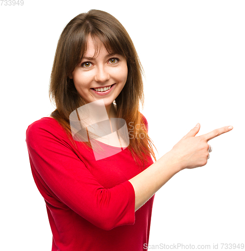 Image of Portrait of a young woman pointing to the right