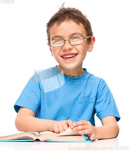 Image of Little boy is reading a book