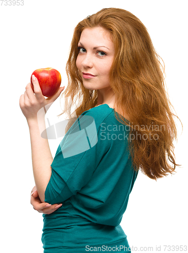 Image of Young happy girl with apple