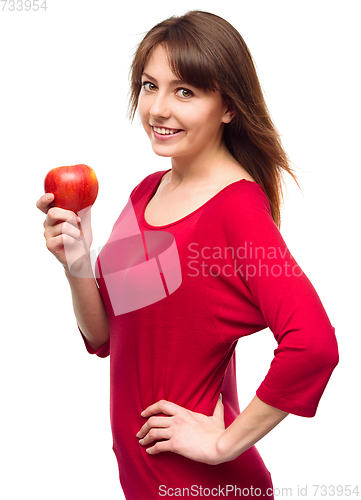 Image of Young happy girl with apple