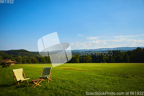 Image of Relax with wooden chair and table. Enjoy the view of garden forest