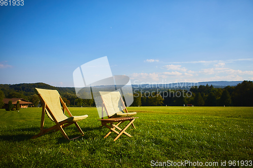Image of Relax with wooden chair and table. Enjoy the view of garden forest