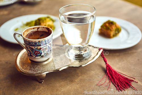 Image of Turkish coffee and turkish delight with traditional embossed metal tray and cup