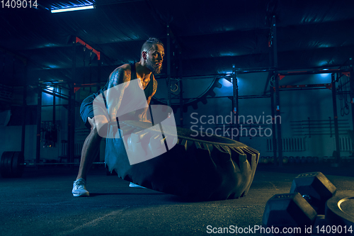 Image of Young healthy man athlete doing exercise in the gym