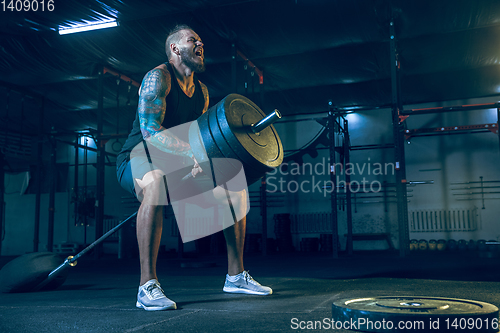 Image of Young healthy man athlete doing exercise in the gym