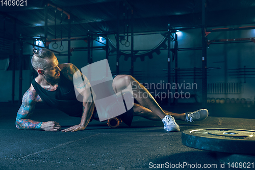 Image of Young healthy man athlete doing exercise in the gym