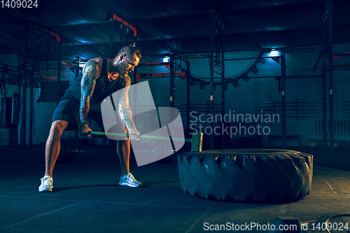 Image of Young healthy man athlete doing exercise in the gym