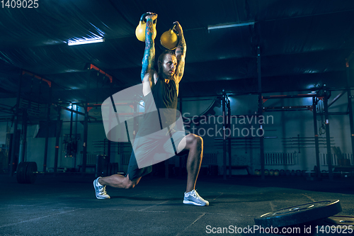 Image of Young healthy man athlete doing exercise in the gym