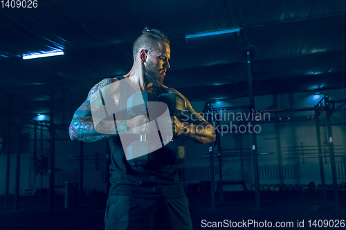 Image of Young healthy man athlete doing exercise in the gym
