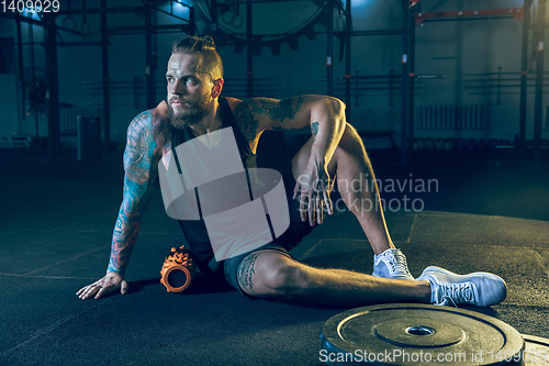 Image of Young healthy man athlete doing exercise in the gym