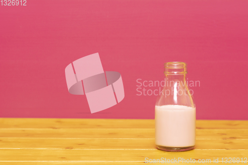 Image of One-third pint milk bottle half full with strawberry milkshake