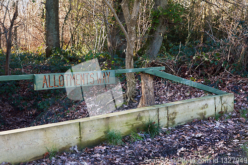 Image of Carved wooden sign for Allotments Way in a wood