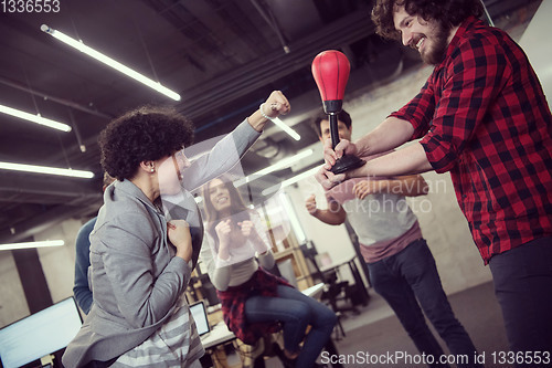 Image of multiethnics business team boxing at office