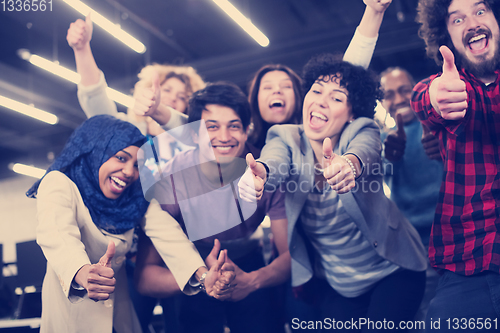 Image of portrait of young excited multiethnics business team