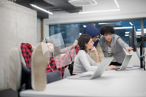 Image of software developer resting with legs on desk