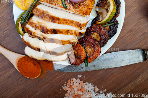 Image of roasted grilled BBQ chicken breast with herbs and spices 