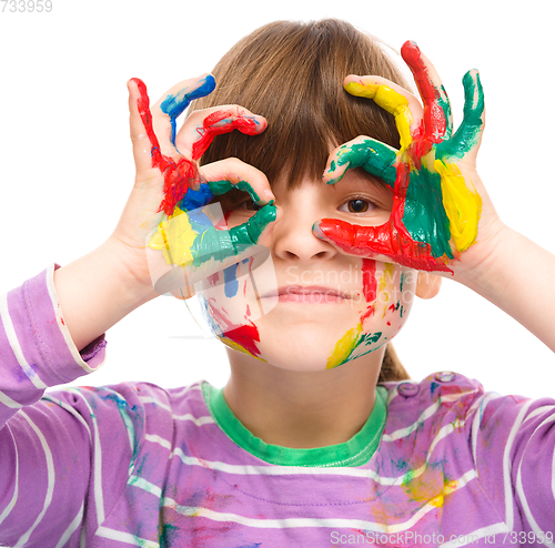 Image of Portrait of a cute girl playing with paints