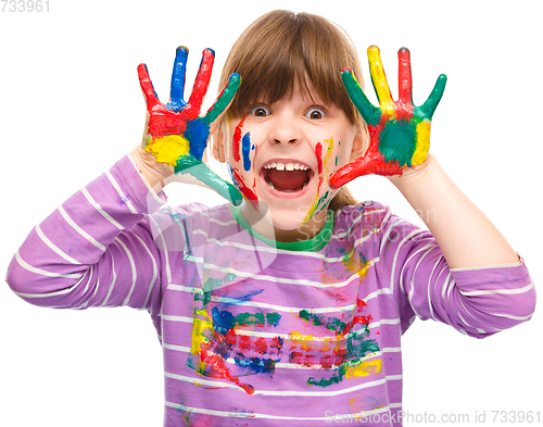 Image of Portrait of a cute girl playing with paints