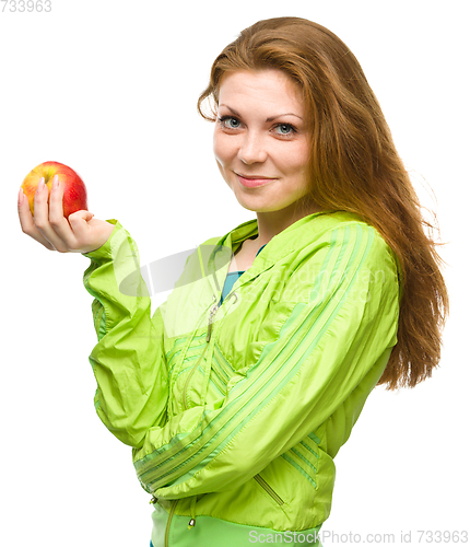 Image of Young happy girl with apple