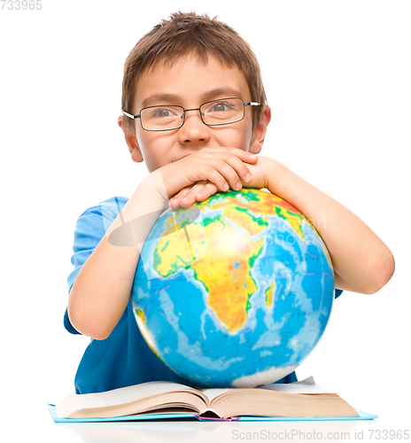 Image of Little boy is holding globe